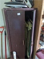 Metal cabinet with old coats n clothes