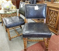 Pair of black leather embossed studded chairs