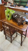 Lot of wooden desk and chair, glass pig jar, and
