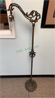 Antique brass and iron floor lamp with an