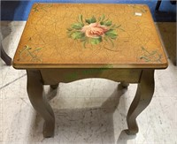 Small side table with a painted pink rose.