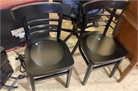 2 small black side chairs with a seat height of