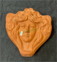 Art nouveau clay well pocket with a woman with