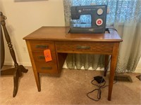 Singer simple sewing machine in cabinet