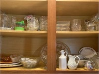 Two shelves of assorted glass, salt and pepper
