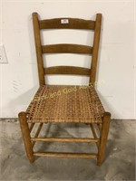 Child’s wooden chair with wicker seat