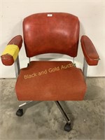 Red vinyl office chair yellow duck tape highlights