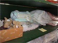 Shelf of 15 new baby blankets, finger puppets