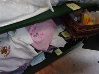 Shelf of 27 new infant/child shirts, baby rattles