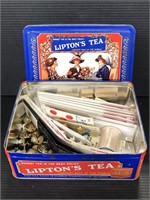 Lipton’s Tea tin of assorted sewing materials