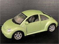 Green Volkswagen Beetle model car on stand
