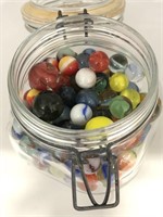 Glass jar of assorted vintage marbles