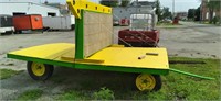 Green and yellow hay wagon with removable sign