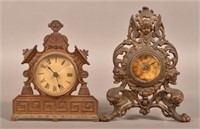 2 Small Cast Iron Cartouche Clocks