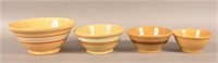 Four Antique Yellowware Mixing Bowls.