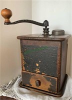 Antique wood coffee grinder with a side handle and