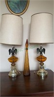 Two amber glass and eagle table lamps with a