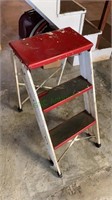 Vintage red and white metal step stool with two