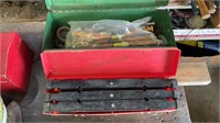 Green toolbox with pipe fitting supplies and an