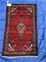 Persian carpet in reds, 5'6” x 9'4”