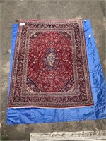 Persian wool carpet in reds, 9'6” x 12'7”.