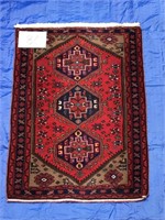 Persian scatter mat in reds (Iran), 3'6” x 4'11”.