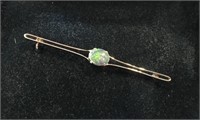 18kt gold bar pin set with an oval Opal.