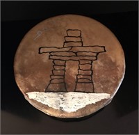 Sealskin Inuit drum decorated with an “Inukshuk” .