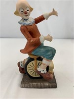 Vintage porcelain clown riding a unicycle