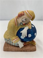 Clown laying on a ball made with porcelain Great