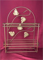 Metal shelf with leaf design