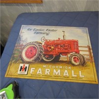 Metal McCormick IH Farmall tractor sign.