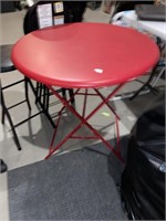 folding round red table and three round stools