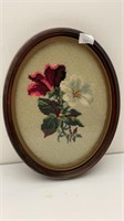 Needlepoint floral artwork in frame