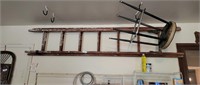 EARLY WOODEN EXTENSION LADDER HANGING IN BACK OFA