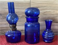 Cobalt blue glassware oil lamp, vase, and jar