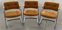 3 orange chairs