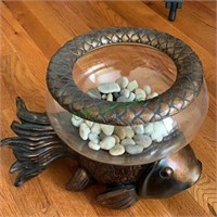 Fishbowl with some river stones in the bottom on