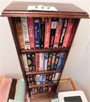 Four shelf wooden display unit full of VHS tapes,