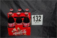6 Coca-Cola Bottles