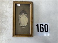 Antique photo of baby in wood frame