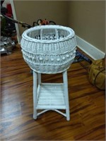 white wicker plant stand with plant