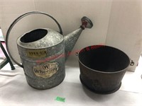 Antique wheeling sprinkling can & cast iron pot