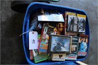 Tote of DVDs, VHS, and CDs.