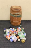 Lot of glass marbles in wood keg