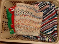 Braided rugs, linens, plastic laundry basket some