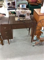 Vintage singer sewing machine in cabinet