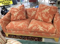 A pair of coral sofas