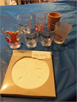 Varies kinds of shot glasses with a coaster in box
