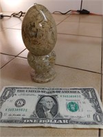 Marble egg in pedestal.